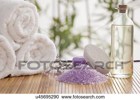 Stock Image - Massage oil and lavender bath salt in spa, Studio shot. Fotosearch