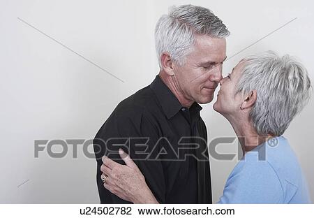 Stock Image - Mature couple kissing. Fotosearch