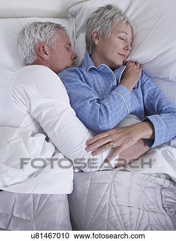 Mature couple sleeping in bed View Large Photo Image Stock Image - Mature couple sleeping in bed. Fotosearch