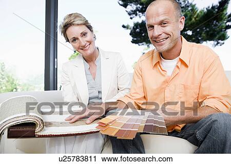 Mature man and interior designer choosing color sample, smiling, portrait View Large Photo Image Stock Image - Mature man and interior designer choosing color sample, smiling, portrait. Fotosearch