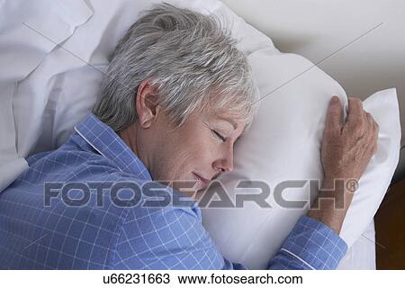 Stock Image - Mature woman sleeping. Fotosearch