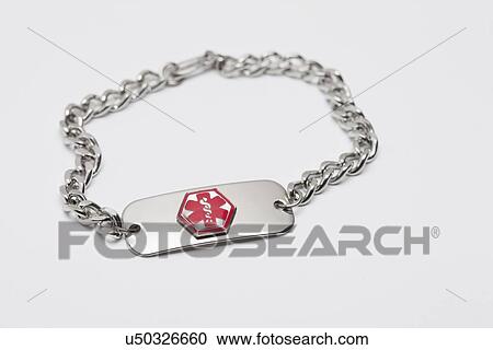 Stock Image - Medical alert tag on white background, studio shot. Fotosearch