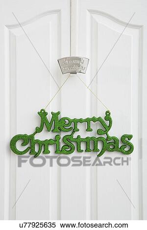 Stock Photography - Merry Christmas sign hanging on door. Fotosearch