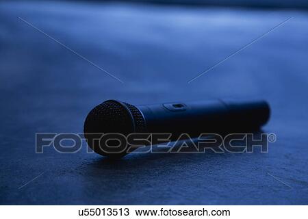 Stock Image - Microphone lying down, blue toned. Fotosearch