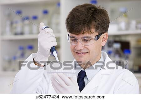 Picture - Mid adult scientist. Fotosearch