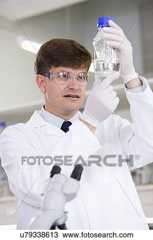 Stock Image - Mid adult scientist. Fotosearch