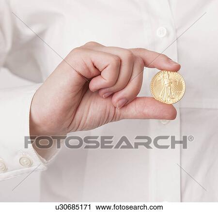 Mid adult woman holding one US dollar coin, studio shot View Large Photo Image Stock Image - Mid adult woman holding one US dollar coin, studio shot. Fotosearch