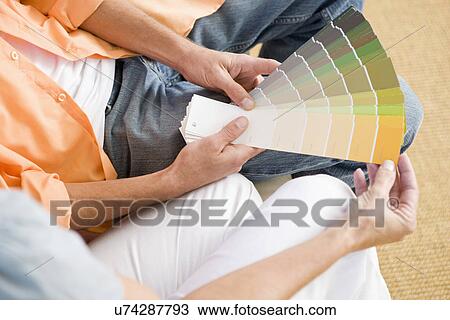 Mid section of couple holding color samples, elevated view View Large Photo Image Stock Image - Mid section of couple holding color samples, elevated view. Fotosearch