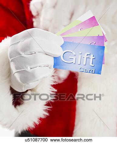 Mid section of Santa holding gift cards View Large Photo Image Stock Image - Mid section of Santa holding gift cards. Fotosearch