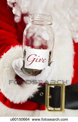 Mid section of Santa holding jar with coins View Large Photo Image Picture - Mid section of Santa holding jar with coins. Fotosearch