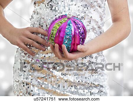 Mid section of teenage girl (14-15) holding Christmas ornament View Large Photo Image Stock Image - Mid section of teenage girl (14-15) holding Christmas ornament. Fotosearch