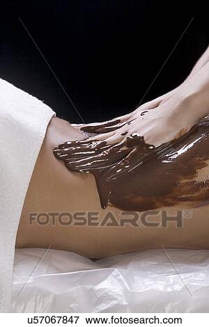 Mid section of woman having chocolate massage View Large Photo Image Stock Photo - Mid section of woman having chocolate massage. Fotosearch
