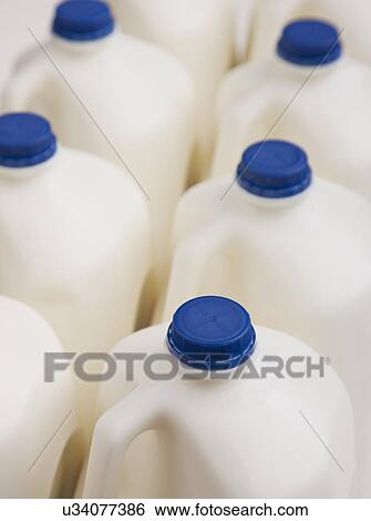 Stock Photograph - Milk bottles with blue caps. Fotosearch