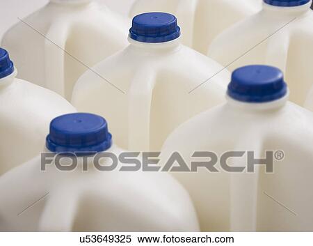 Stock Photography - Milk bottles with blue caps. Fotosearch