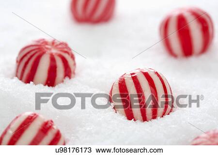 Stock Image - Mint candies in snow. Fotosearch