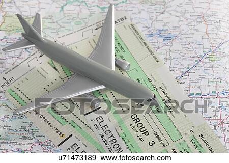 Stock Photo - Model airplane and airplane tickets on map. Fotosearch