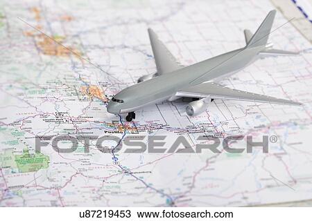Stock Image - Model airplane on map. Fotosearch