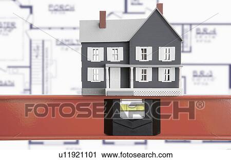 Stock Image - Model house against blue print. Fotosearch