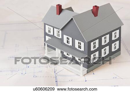Stock Photo - Model house on blueprint. Fotosearch