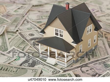 Stock Image - Model house on dollar bills. Fotosearch