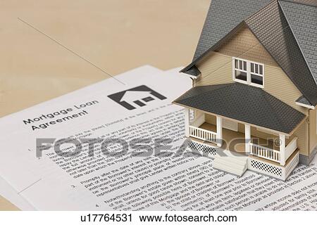 Model house on mortgage document View Large Photo Image Stock Image - Model house on mortgage document. Fotosearch
