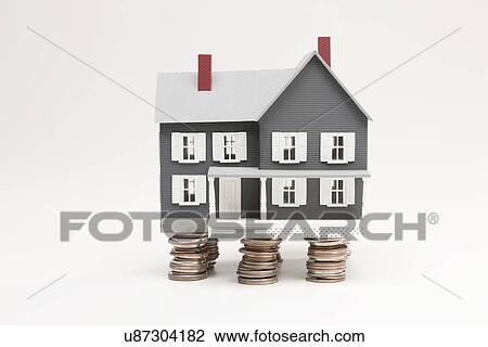 Model house standing on coin stacks View Large Photo Image Stock Image - Model house standing on coin stacks. Fotosearch