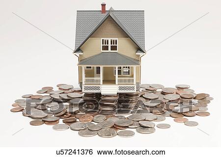 Model house surrounded by coins View Large Photo Image Stock Photograph - Model house surrounded by coins. Fotosearch