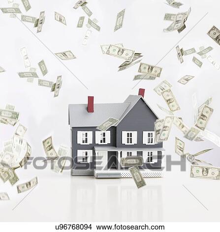 Model house surrounded by flying banknotes View Large Photo Image Picture - Model house surrounded by flying banknotes. Fotosearch