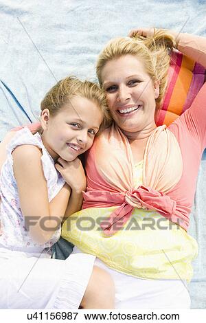 Mother and daughter (8-9) embracing, portrait View Large Photo Image Stock Photo - Mother and daughter (8-9) embracing, portrait. Fotosearch