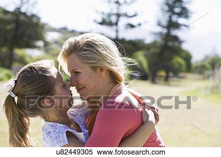 Mother and daughter (8-9) face to face in park View Large Photo Image Stock Photography - Mother and daughter (8-9) face to face in park. Fotosearch