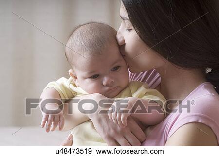 Mother kissing baby (6-11 months) View Large Photo Image Stock Photo - Mother kissing baby (6-11 months). Fotosearch