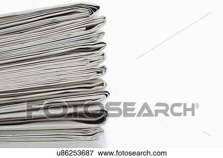Newspaper stack on white background, close-up View Large Photo Image Stock Photo - Newspaper stack on white background, close-up. Fotosearch