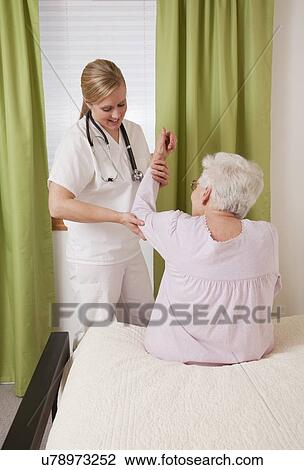 Nurse exercising with senior woman View Large Photo Image Stock Image - Nurse exercising with senior woman. Fotosearch