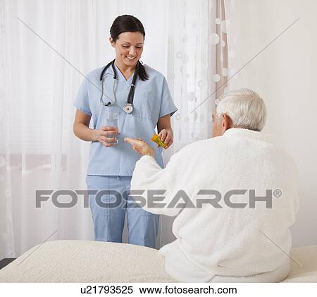Nurse giving medicine to senior patient View Large Photo Image Stock Photography - Nurse giving medicine to senior patient. Fotosearch