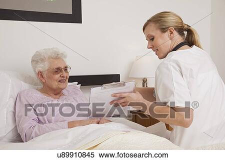 Nurse showing senior patient medical chart View Large Photo Image Stock Photography - Nurse showing senior patient medical chart. Fotosearch