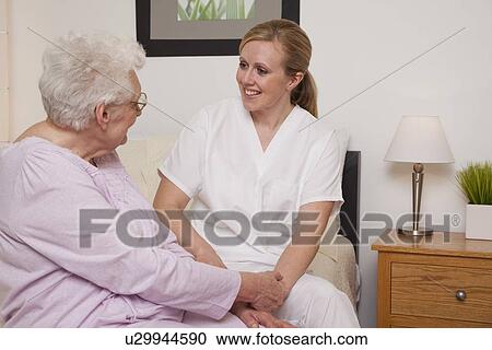 Nurse talking with senior patient View Large Photo Image Stock Image - Nurse talking with senior patient. Fotosearch