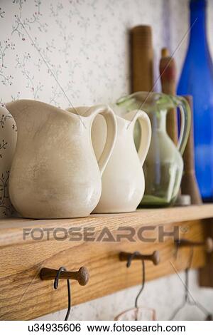 Old-fashioned jugs on shelf View Large Photo Image Stock Photograph - Old-fashioned jugs on shelf. Fotosearch