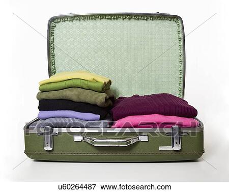 Stock Photo - Open suitcase with cloths, studio shot. Fotosearch