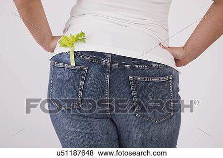 Overweight woman with celery in back jeans pocket, mid section, rear view View Large Photo Image Stock Photo - Overweight woman with celery in back jeans pocket, mid section, rear view. Fotosearch