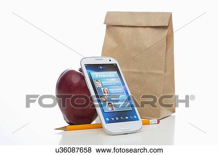 Paper bag, apple, cell phone and pencil on white background View Large Photo Image Stock Photo - Paper bag, apple, cell phone and pencil on white background. Fotosearch