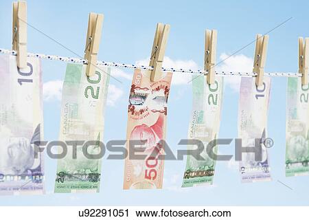 Paper currency hanging on clothesline View Large Photo Image Stock Image - Paper currency hanging on clothesline. Fotosearch