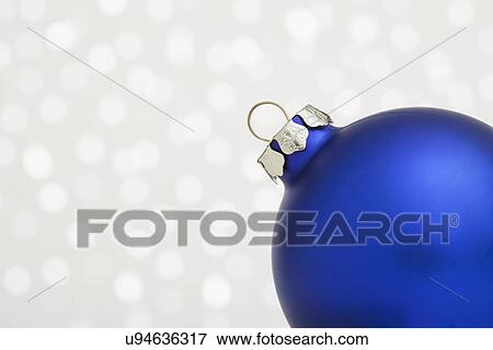 Stock Photo - Part of Christmas bulb on sparkled background. Fotosearch