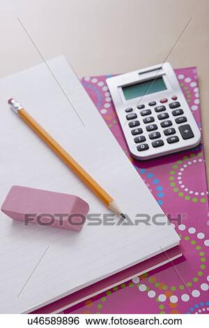 Stock Photograph - Pencil and calculator on notebook. Fotosearch