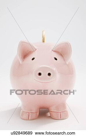 Stock Photo - Piggyback with gold coin, studio shot. Fotosearch