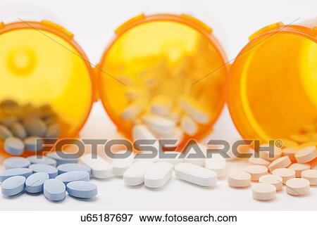 Stock Photo - Pills and prescription bottle, studio shot. Fotosearch