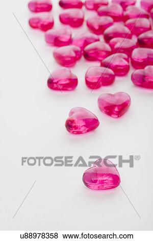 Stock Photo - Pink glass hearts on white background. Fotosearch