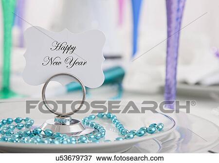 Stock Photo - Place setting with card 'Happy New Year'. Fotosearch