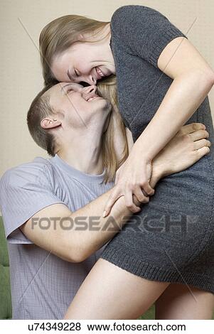 Stock Photo - Playful young couple embracing. Fotosearch