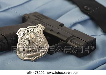 Police badge and gun View Large Photo Image Stock Image - Police badge and gun. Fotosearch