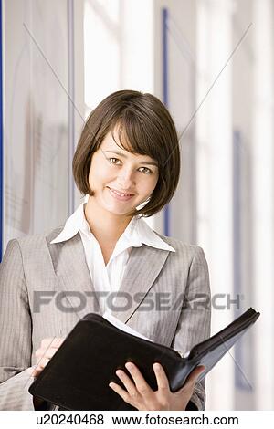 Portrait of businesswoman with briefcase View Large Photo Image Stock Photo - Portrait of businesswoman with briefcase. Fotosearch